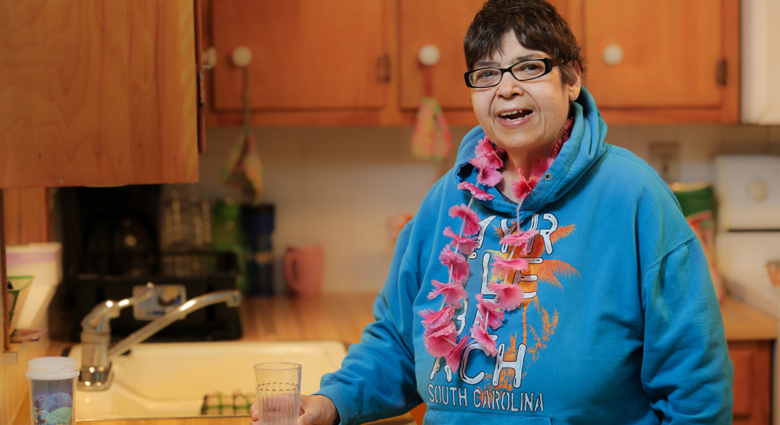Gina Pirillo posing for a photo in her kitchen.