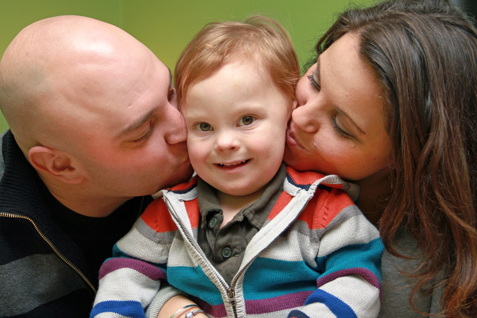 Shon and Brittany give their son Beckett a kiss on the cheek