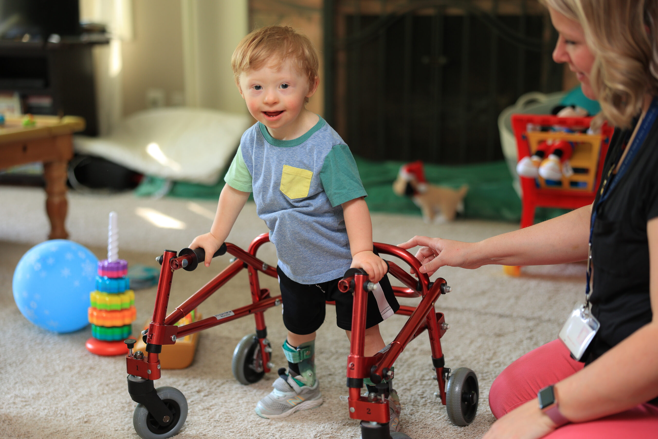 William William, a child who receives Summit DD services, using his walker.